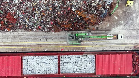 Large scrap yard shows a collection of metal waste being processed for recycling Stock Footage 341106089
