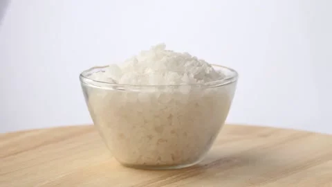 Large sea salt is poured into cup Stock Footage 88090256