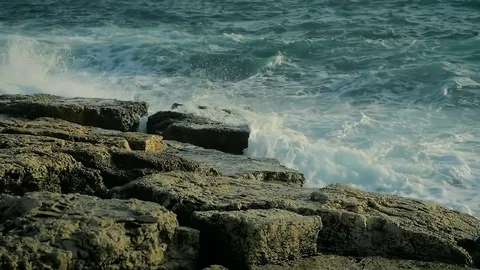 Large sea waves beautifully splash on the rocks on the beach in slow motion. Stock Footage 84653366