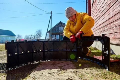 Large segmented compost section being connected with stackable plastic comp.. Stock Photos