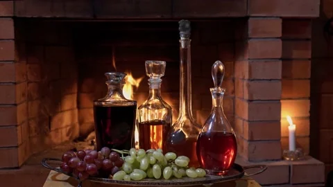 A large selection of alcoholic tinctures on the background of the fireplace Stock Footage 166241283