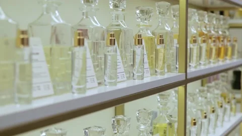 Large selection of body fragrances. Perfume rack. Luxurious perfume in a Stock-Footage 225082777