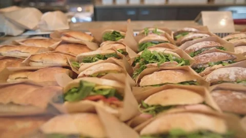 Large selection of sandwiches lined up in cafe display ready for sale Stock Footage 320089739