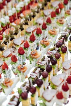 A large selection of various snacks for guests on a mirror surface. Buffet 스톡 사진