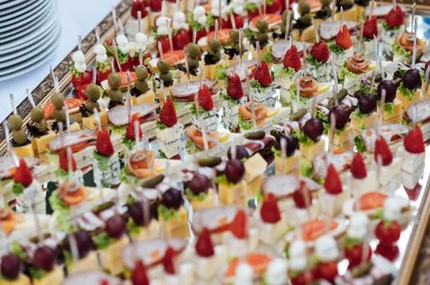 A large selection of various snacks for guests on a mirror surface. Buffet be Stock Photos