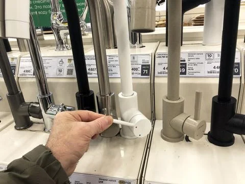Large selection of water taps for kitchen in the supermarket. Stock Photos