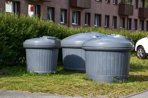 Large Semi-Underground Waste Containers Near Apartment Building Stock Photos