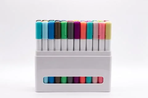 A large set of multicolored felt tip markers arranged in a white box. Stock Photos