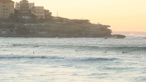 Large set of waves come through Bondi Beach during sunrise in slow motion Stock Footage 90891281