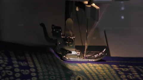 A large sewing machine working on colorful cloth and stitching Stock Footage 112855125