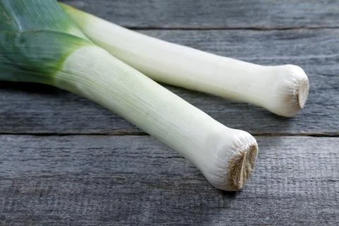 Large shallot stalks on a rustic table Stock Photos