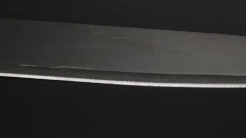 Large sharp knife with stainless steel handle isolated on black background. Stock Footage 248272849