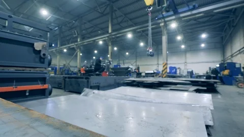 Large sheets of metal are lying in the factory facility. Video stock 123435421