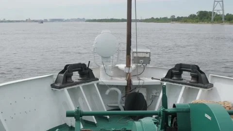 Large ship bow with green and white equipment sails on river Stock Footage 155286309