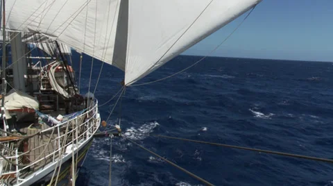 A large ship (a clipper) sailing on open sea, filmed from the stern of the ship, Stock Footage 39483137