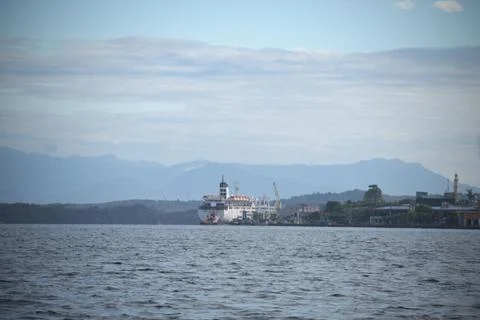 A large ship is docked at the pier in a small town Stock Photos