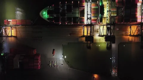 Large ship is docked at a port at night Stock Footage 327575058