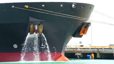 Large ship dump ballast water at the port 4k Stock Footage 89941477