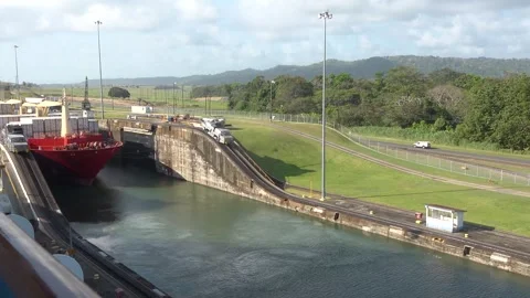 Large ship passes through Panama Canal locks during daylight near the city. Vídeo Stock 331385016