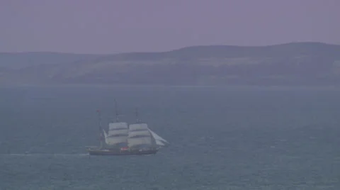 A large ship sailing along the shore under an orange sky. Stock Footage 39483714