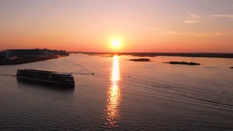 A large ship at sunset is moving at the confluence of two rivers.The sun is at s Stock Footage 163588302