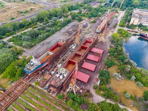 Large shipyard at a port showing multiple ships and repair docks with crane.. 스톡 사진