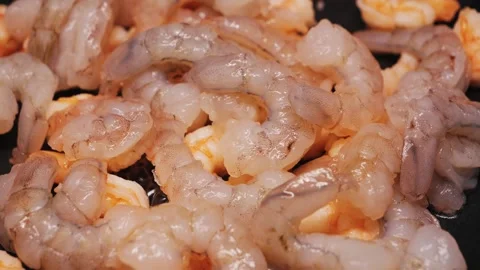 Large shrimps are fried in a pan, a valuable product for dietary nutrition. Stock Footage 330287751