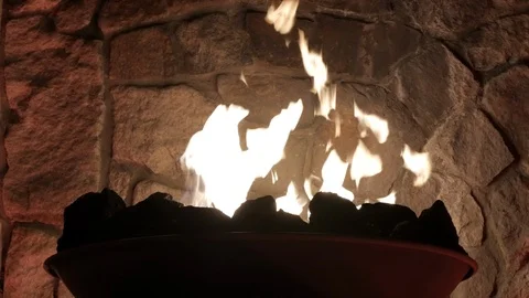 Large silhouetted fire torch Illuminating stone wall background Stock Footage 103967164