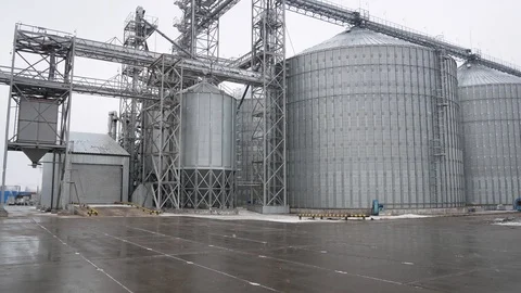 Large silos with grain in early spring in the farm Stock Footage 107655871