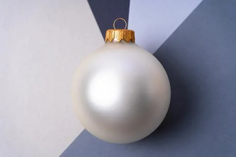 A large silver Christmas ball at the intersection of shades of gray. Stock Photos