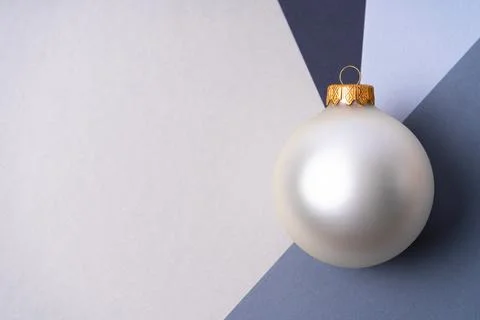 A large silver Christmas ball at the intersection of shades of gray. Stock-Fotos