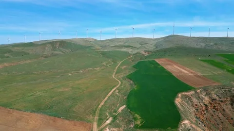 A large sinkhole, lake and wind turbines Stock Footage 274846129