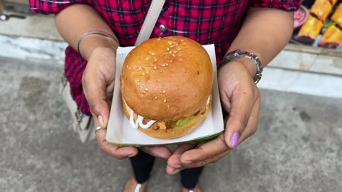 Large sized burger filled with fried chicken in Kolkata Stock Footage 310867499