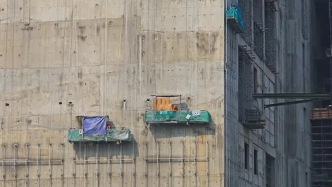 Large skyscraper development structure showing external staging equipment and Stock Footage 337989554
