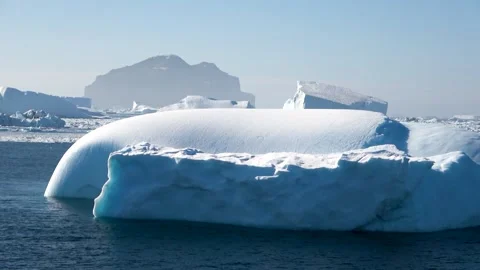 Large smooth iceberg drifting ocean Antarctica, 4K Stock Footage 332372872