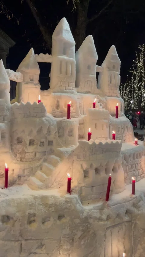 Large Snow Castle with Candles at Night in Winter Видео 346490086