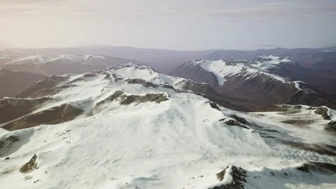 Large snow patch left over on the volcanic rock field of a mountain in summer Video stock 229467468