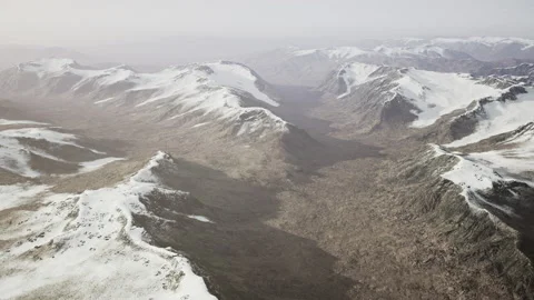 Large snow patch left over on the volcanic rock field of a mountain in summer Video stock 231809794