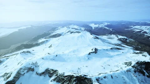 Large snow patch left over on the volcanic rock field of a mountain in summer Video stock 236326494