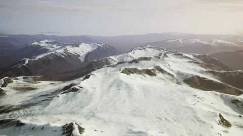 Large snow patch left over on the volcanic rock field of a mountain in summer Stock Footage 238693634
