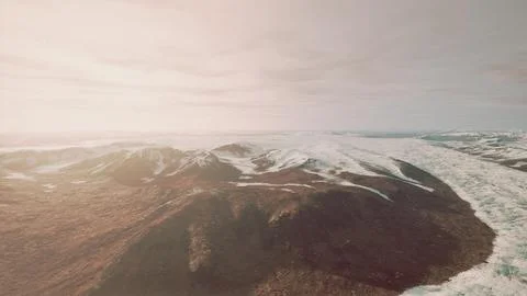 Large snow patch left over on the volcanic rock field of a mountain in summer Ilustración de archivo