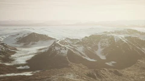 Large snow patch left over on the volcanic rock field of a mountain in summer Ilustración de archivo