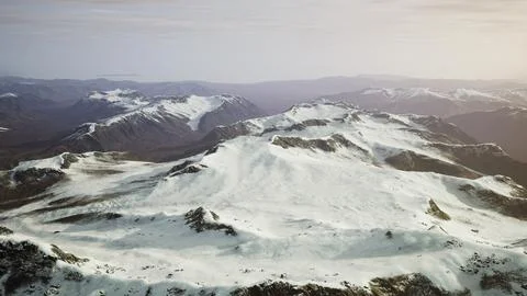 Large snow patch left over on the volcanic rock field of a mountain in summer Ilustración de archivo