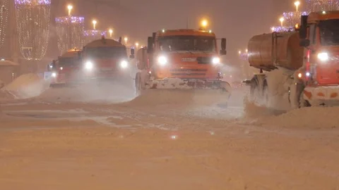 Large snowfall. There are many snowblowers driving along street. Night shooting Stock Footage 149149189