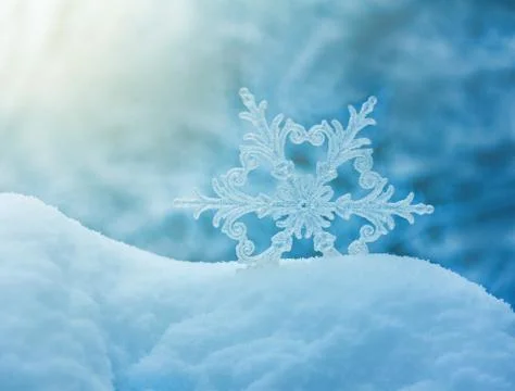 Large snowflake in a snowdrift on a blue background closeup Stock Illustration