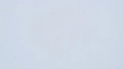 Large snowflakes soar flying over city against foggy sky Stock Footage 125994884