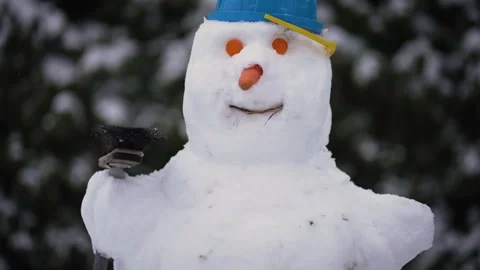 Large snowman crafted by children in backyard during winter season portrait Stock Footage 253263723