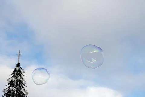 Large soap bubble floating above winter Lisbon square Stock Photos