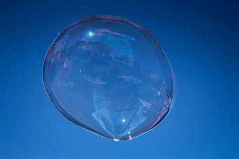 Large soap bubble with reflection in the blue sky Stock Photos