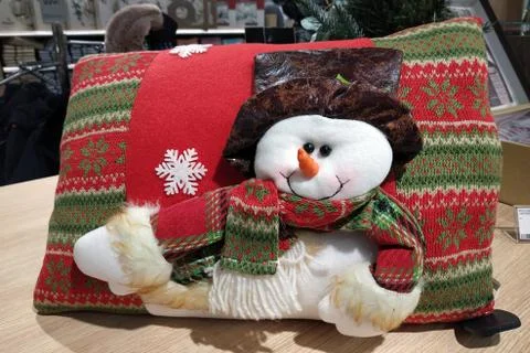 Large soft pillow with a snowman. Scenery for christmas. Bright pillow with d Stock Photos